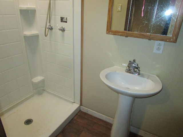 bathroom with a shower and hardwood / wood-style floors