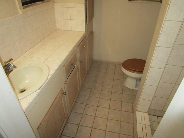 bathroom featuring tile patterned flooring, vanity, and toilet