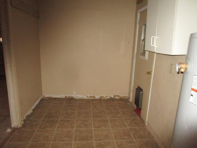 interior space featuring water heater and dark tile patterned floors