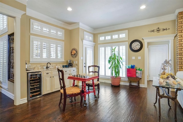 dining room with ornamental molding, dark wood-type flooring, wet bar, and wine cooler