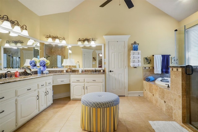 bathroom with vanity, ceiling fan, tile patterned floors, and high vaulted ceiling