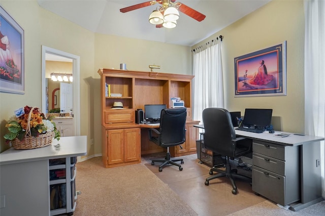 office space with vaulted ceiling, light carpet, and ceiling fan