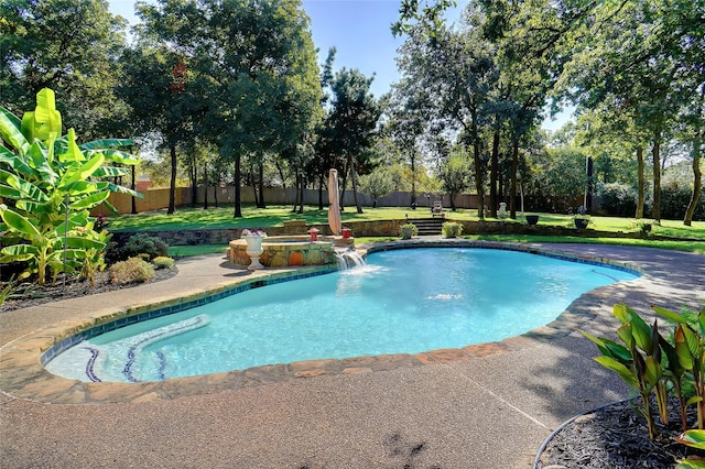 view of swimming pool with a lawn and pool water feature