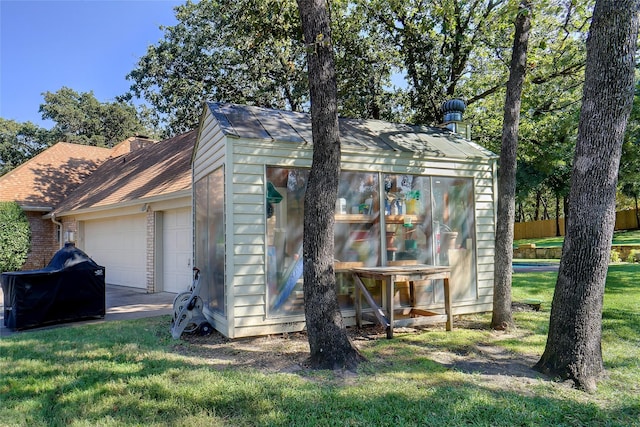 view of outbuilding with a garage and a yard