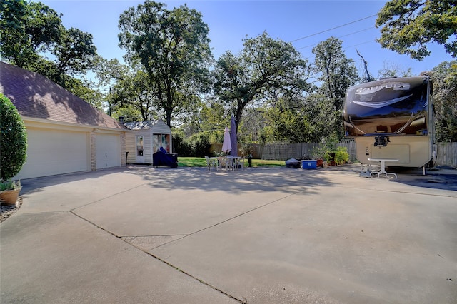 exterior space featuring a garage and a storage unit