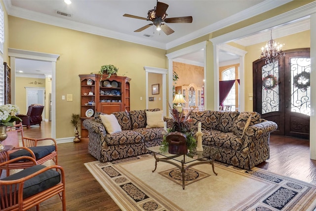 living room with dark wood-type flooring, ornamental molding, and french doors