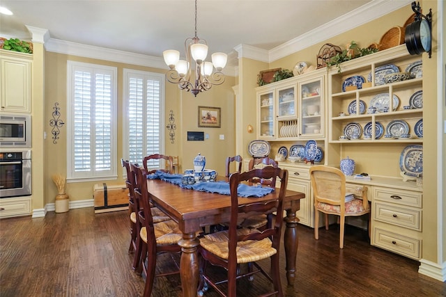 dining area with ornamental molding, dark hardwood / wood-style floors, built in desk, and a notable chandelier