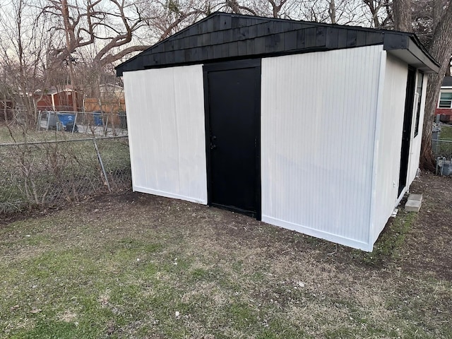 view of shed with fence