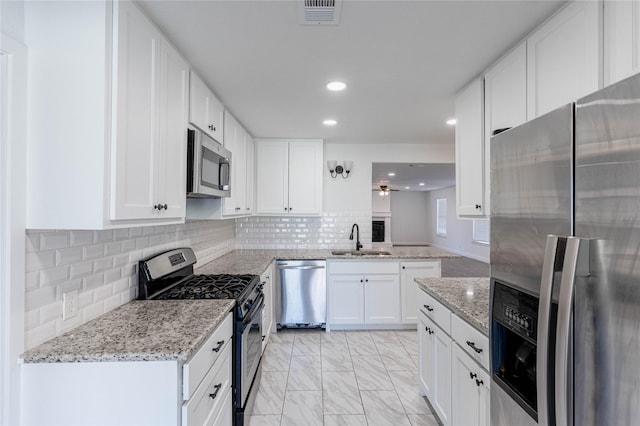 kitchen featuring a sink, visible vents, white cabinetry, marble finish floor, and appliances with stainless steel finishes