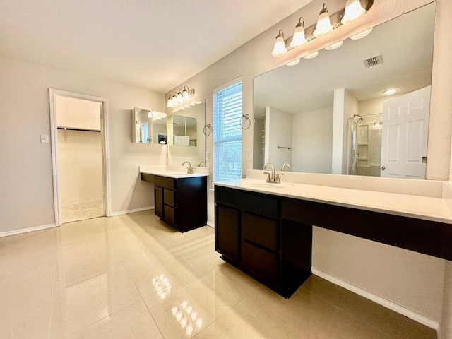 bathroom featuring walk in shower and vanity