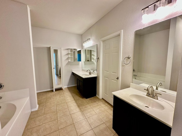 bathroom with vanity, tile patterned flooring, and a tub