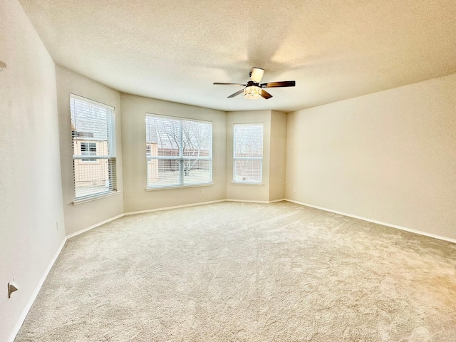 carpeted spare room with ceiling fan and a textured ceiling