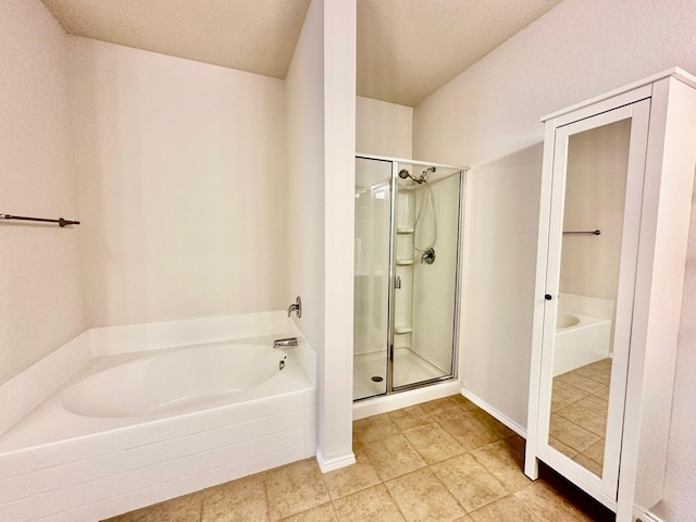 bathroom featuring tile patterned flooring and separate shower and tub