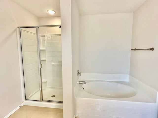 bathroom featuring tile patterned floors and shower with separate bathtub