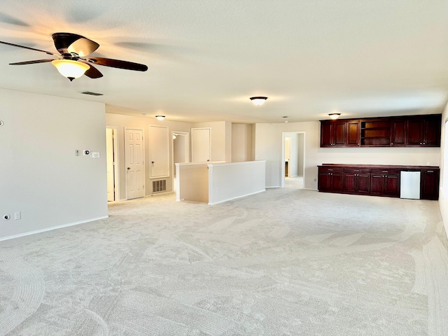 unfurnished living room with light carpet and ceiling fan