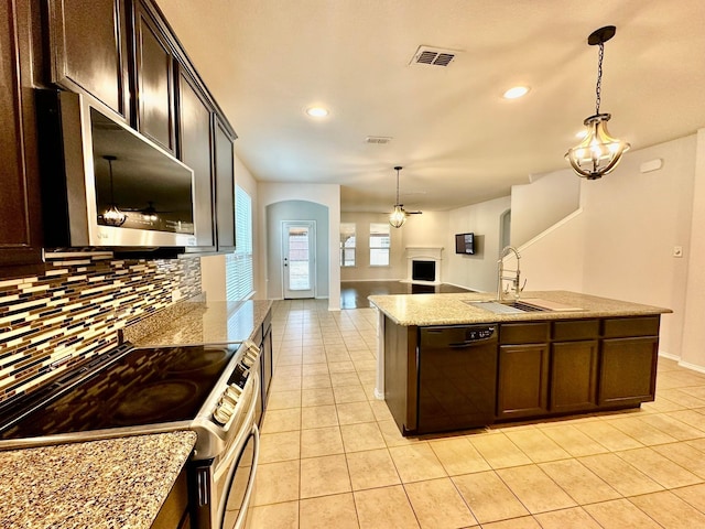 kitchen featuring hanging light fixtures, appliances with stainless steel finishes, sink, and dark brown cabinets