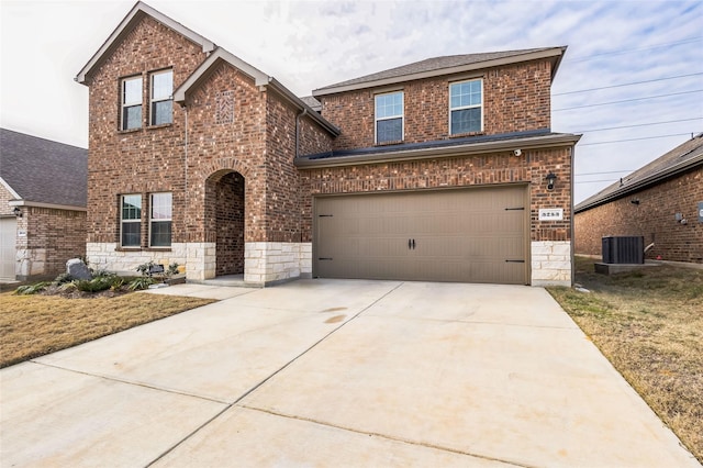 traditional home with driveway, stone siding, central AC unit, and brick siding