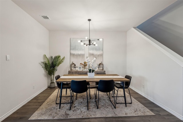 dining space with a notable chandelier, baseboards, visible vents, and dark wood-style flooring