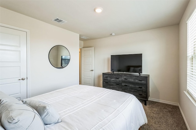 bedroom featuring carpet floors, visible vents, and baseboards