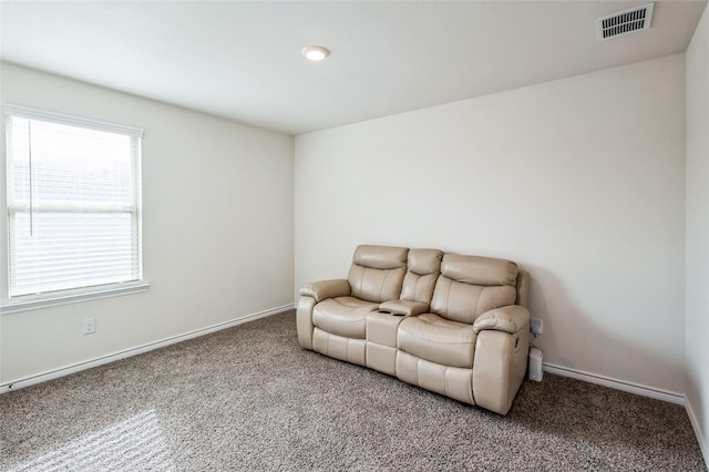 sitting room with carpet, visible vents, and baseboards