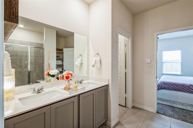 full bath featuring double vanity, a sink, a shower stall, and tile patterned floors