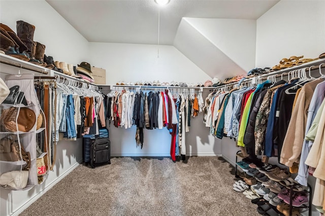 spacious closet with lofted ceiling and carpet floors