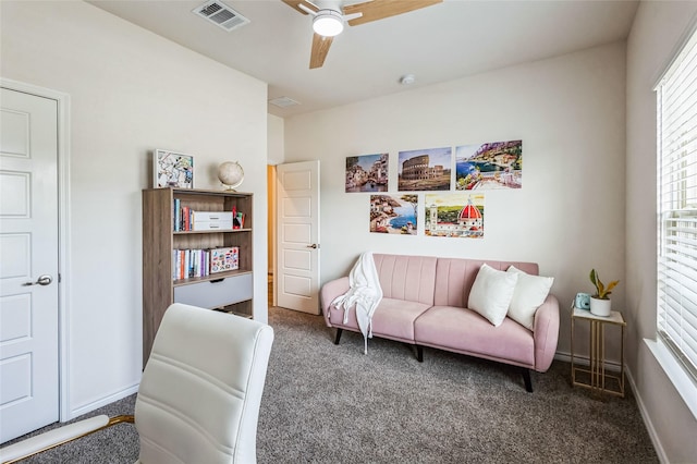 living area with a ceiling fan, carpet, visible vents, and baseboards