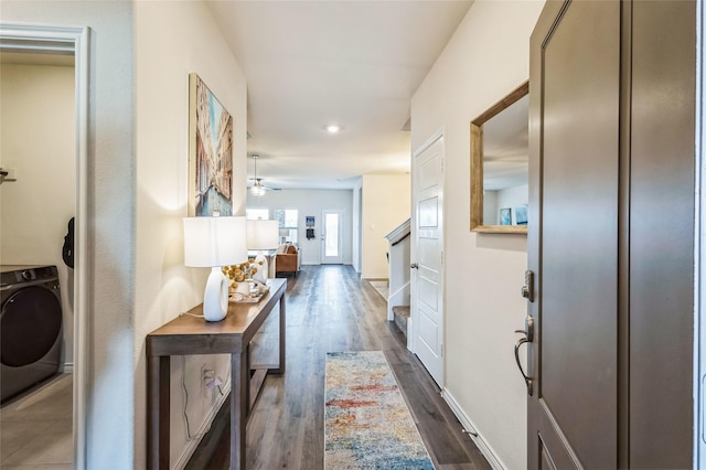 corridor featuring dark wood finished floors and washer / dryer