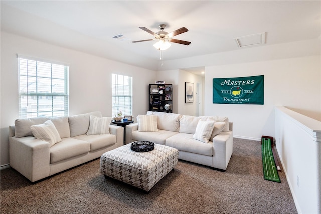 living area featuring ceiling fan, carpet, visible vents, and baseboards