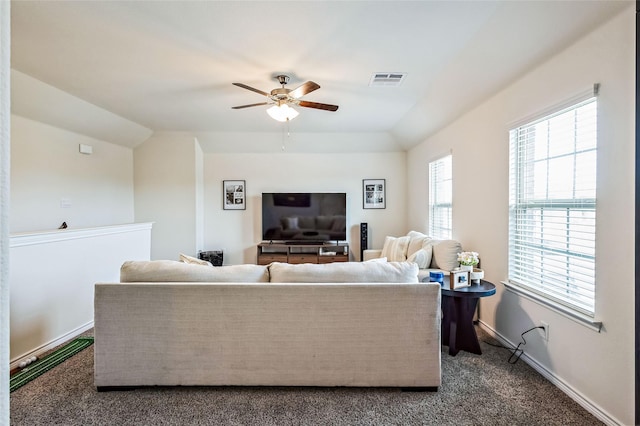 living area with visible vents, dark carpet, vaulted ceiling, ceiling fan, and baseboards