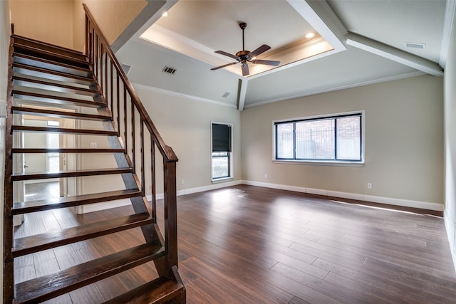 stairs featuring crown molding, wood-type flooring, a raised ceiling, and ceiling fan