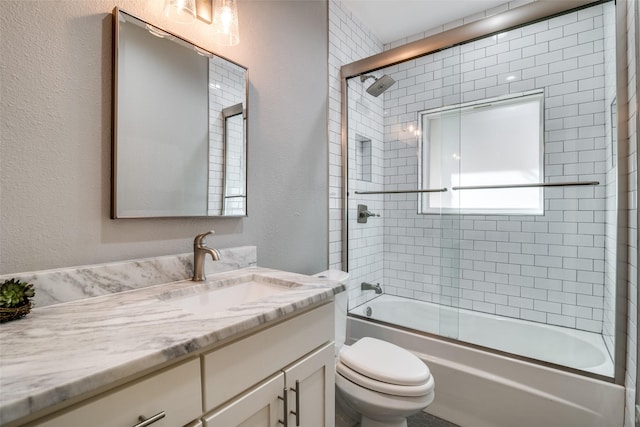 full bathroom with vanity, enclosed tub / shower combo, and toilet