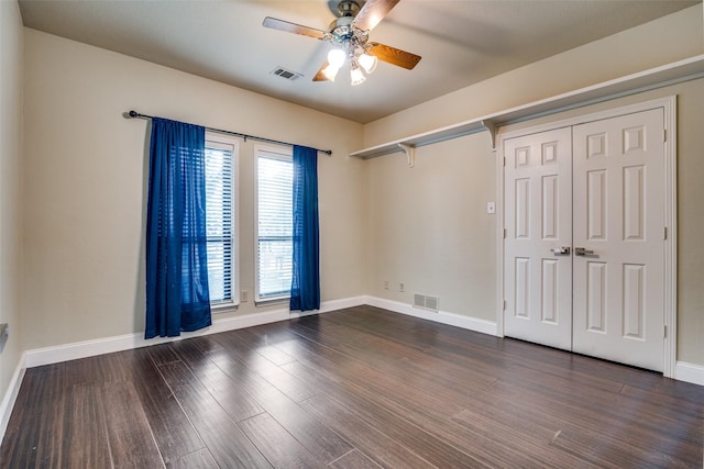 unfurnished room featuring dark hardwood / wood-style floors and ceiling fan