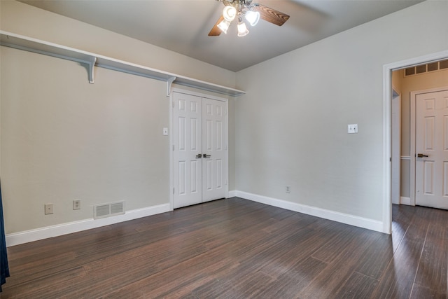 unfurnished bedroom featuring ceiling fan, dark hardwood / wood-style flooring, and a closet