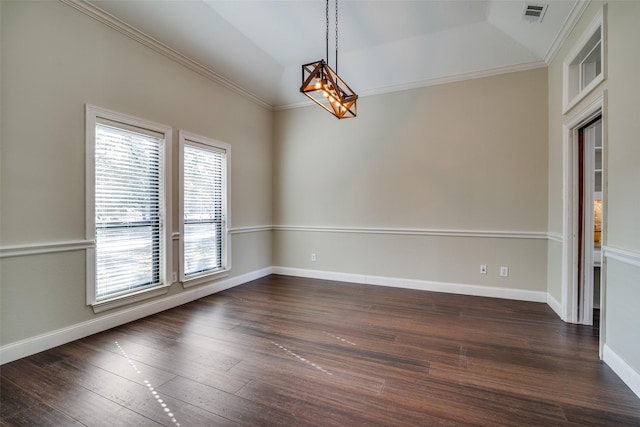 spare room featuring ornamental molding, dark hardwood / wood-style flooring, and vaulted ceiling