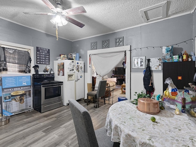 dining room with wood-type flooring, ornamental molding, ceiling fan, and a textured ceiling