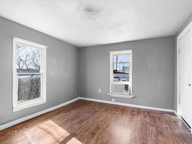 empty room with dark hardwood / wood-style flooring