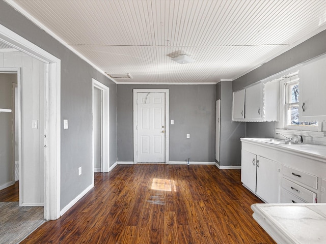 kitchen with white cabinetry, dark hardwood / wood-style floors, sink, and wooden ceiling