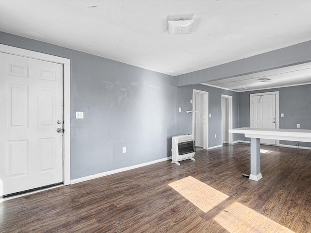 interior space with dark wood-type flooring and heating unit