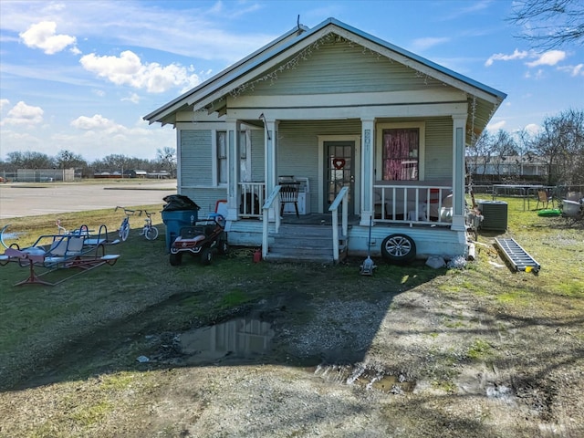 view of front of property featuring covered porch and a trampoline