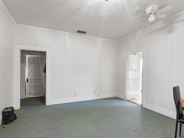 carpeted spare room with ornamental molding and ceiling fan