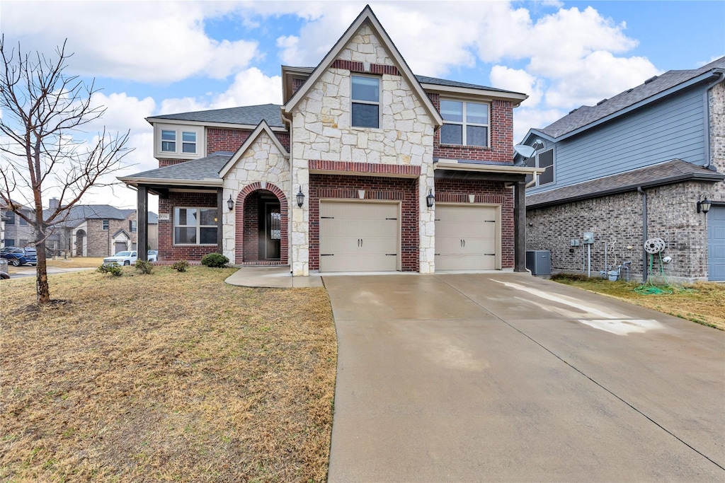 view of front of home featuring a front yard and a garage