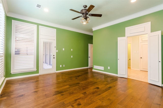 interior space featuring dark hardwood / wood-style flooring, ornamental molding, and ceiling fan