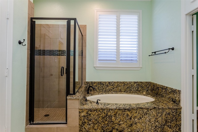 bathroom with separate shower and tub