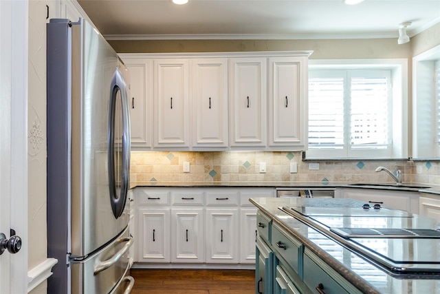 kitchen featuring white cabinets, sink, and stainless steel fridge