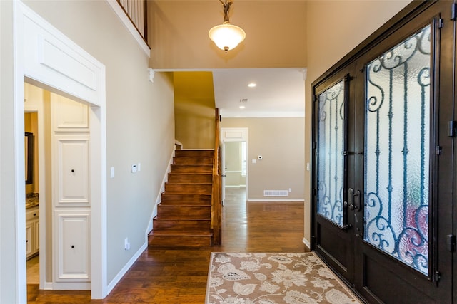 foyer with dark wood-type flooring and french doors