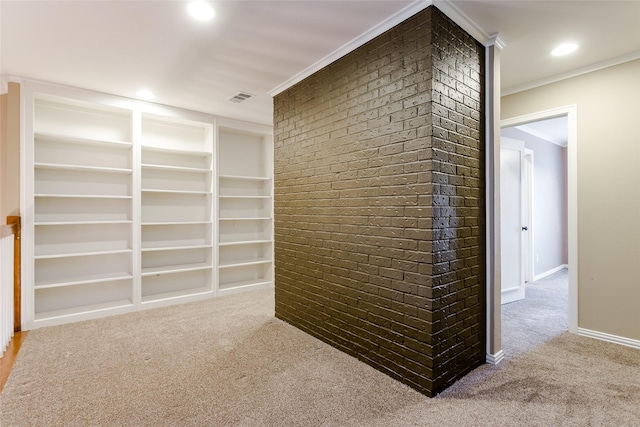 hall with crown molding, built in features, brick wall, and carpet flooring