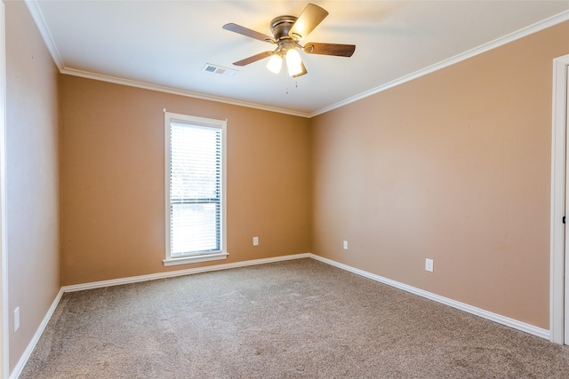 spare room featuring ornamental molding, carpet flooring, and ceiling fan