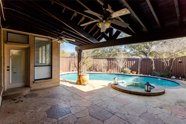 view of pool with a patio and an in ground hot tub