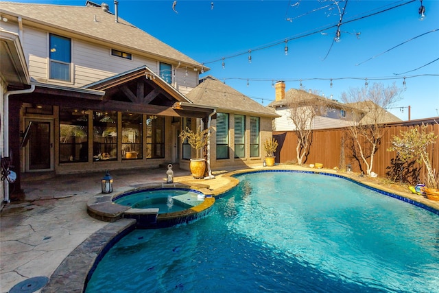 view of pool featuring a patio and an in ground hot tub